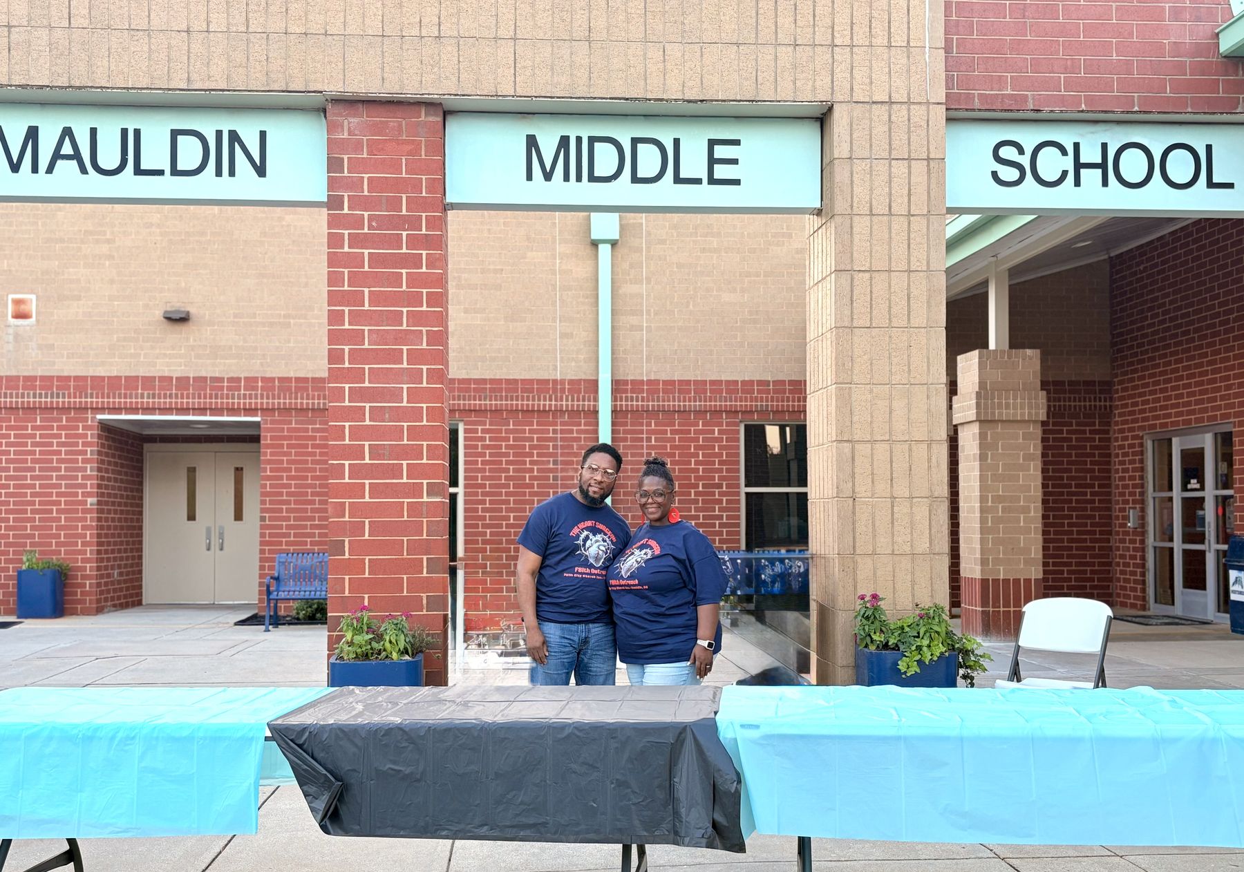 Volunteers at the welcome table outside Mauldin Middle School