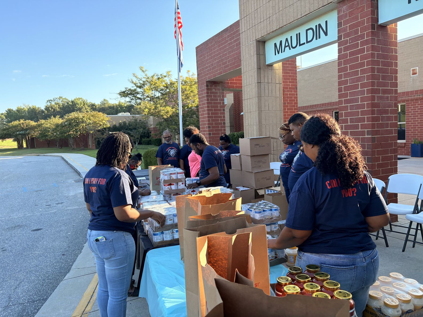 F8ith outreach volunteers preparing groceries for community distribution