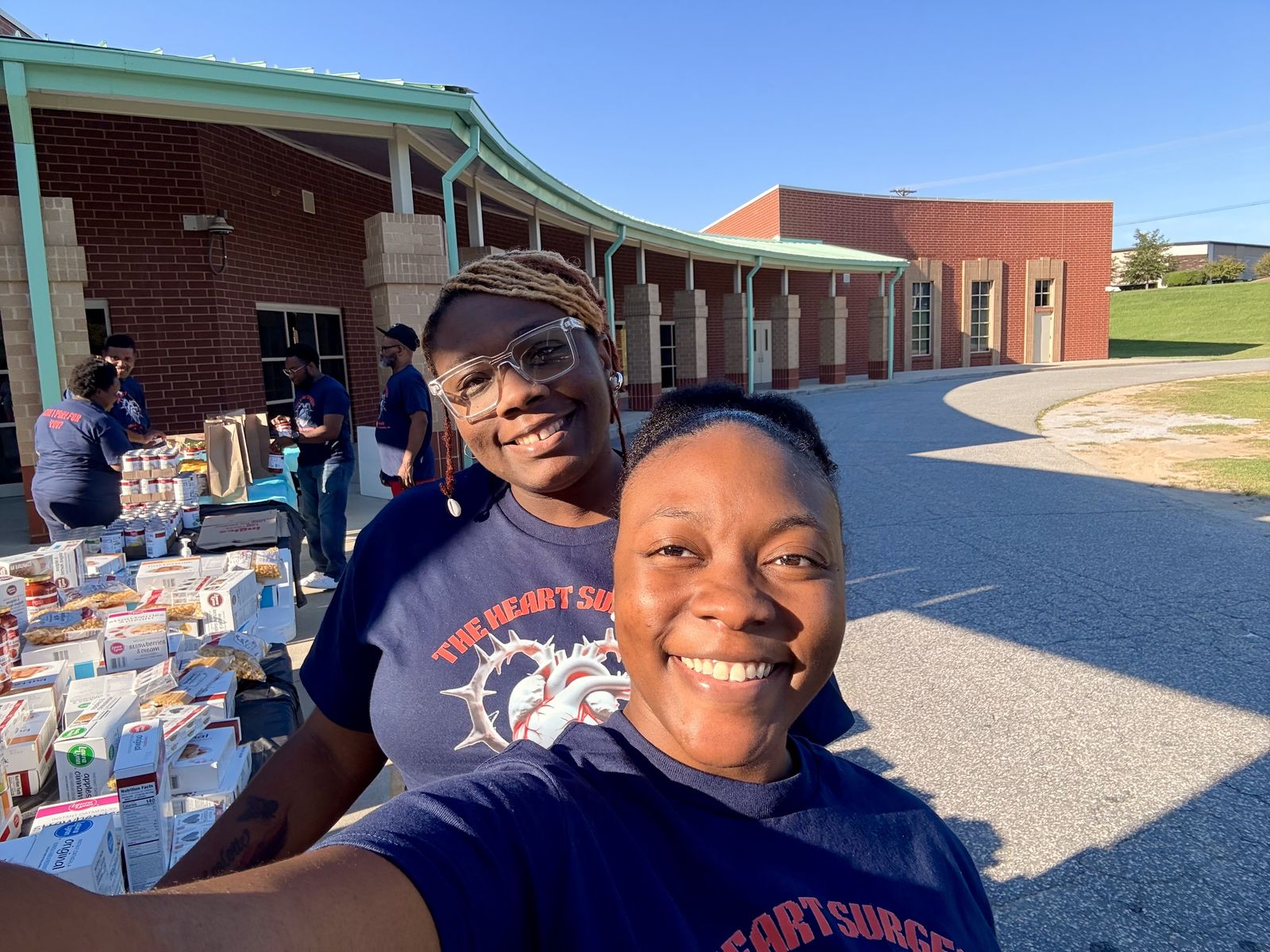Two outreach volunteers smiling at a distribution