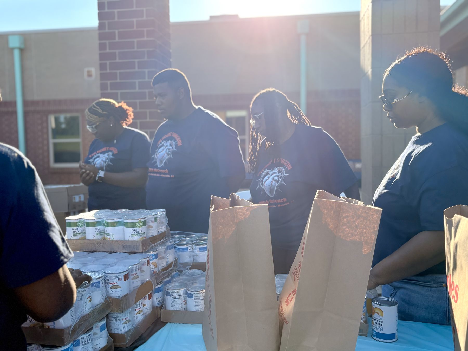 Heart Crew volunteers packing groceries for families